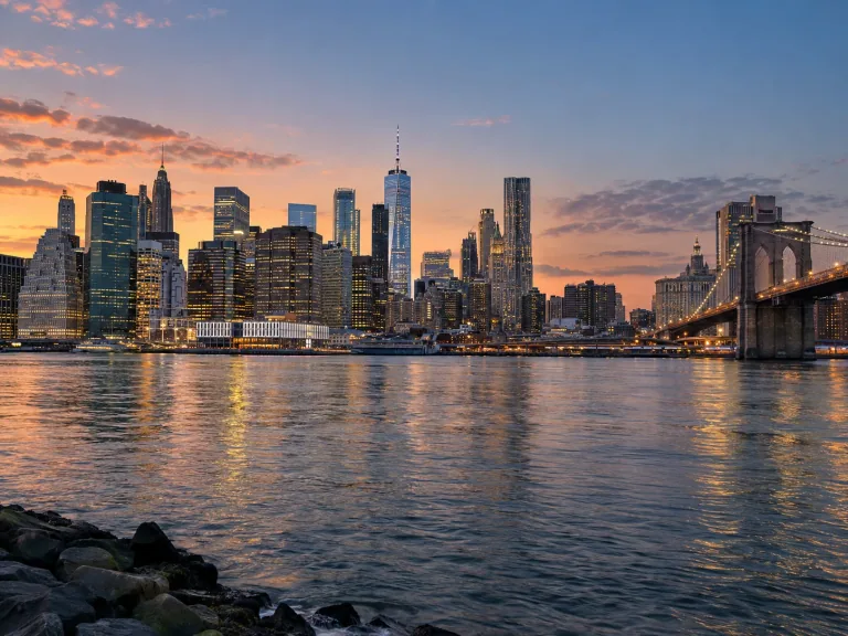 Lower Manhattan skyline across the East River at sunset